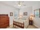 Bright bedroom with neutral walls, a ceiling fan, and classic furniture at 1386 Longley Pl, Deland, FL 32724
