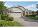Inviting home with a brick-paved driveway, two-car garage, and professionally landscaped front yard at 1386 Longley Pl, Deland, FL 32724