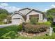 Well-maintained home featuring a lush landscaped front yard and a brick-paved driveway at 1386 Longley Pl, Deland, FL 32724