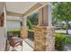 Cozy front porch featuring stone columns and comfortable seating at 1386 Longley Pl, Deland, FL 32724