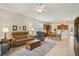 Open-concept living room flows into kitchen, with comfortable seating at 1386 Longley Pl, Deland, FL 32724