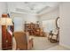 Cozy living room features neutral walls, a tray ceiling, and built-in bookshelves at 1386 Longley Pl, Deland, FL 32724