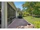 This home has a brick patio, a screened in porch, a built-in fire pit, and a beautiful backyard at 1386 Longley Pl, Deland, FL 32724