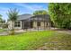 Spacious backyard view of the screened pool, lawn, and landscaping at 140 Rangeline Woods Cv, Longwood, FL 32750