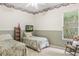 Inviting bedroom with twin beds offers a serene retreat and a view of the backyard at 140 Rangeline Woods Cv, Longwood, FL 32750