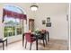 Dining room with tile floor, chandelier, dining table, and large window that offers plenty of natural light at 140 Rangeline Woods Cv, Longwood, FL 32750