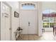Bright entryway with tile flooring, featuring a white double door and decorative glass table at 140 Rangeline Woods Cv, Longwood, FL 32750