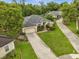 Aerial view of house with a large lawn and driveway at 140 Rangeline Woods Cv, Longwood, FL 32750
