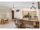Open-concept kitchen with bar seating offers a seamless flow to the dining area at 140 Rangeline Woods Cv, Longwood, FL 32750