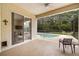 Covered lanai with view of the backyard pool at 140 Rangeline Woods Cv, Longwood, FL 32750