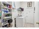 Laundry room with washer, shelving and tile floor at 140 Rangeline Woods Cv, Longwood, FL 32750