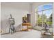 Bright living room featuring a large arched window and artist's easel with painting at 140 Rangeline Woods Cv, Longwood, FL 32750