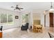 Sunny living room with tile flooring, sliding glass doors, and views of the back yard at 140 Rangeline Woods Cv, Longwood, FL 32750