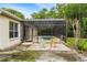 Backyard view of screened pool with chairs on a brick patio at 140 Rangeline Woods Cv, Longwood, FL 32750
