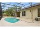 Backyard view of the screened pool with a covered patio and exterior door at 140 Rangeline Woods Cv, Longwood, FL 32750