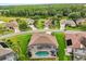 Aerial view of a screened-in pool and backyard in a residential neighborhood surrounded by lush greenery at 14174 Islamorada Dr, Orlando, FL 32837