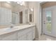 Bathroom featuring a single sink vanity, shower, and outdoor access at 14174 Islamorada Dr, Orlando, FL 32837