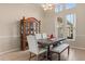 Bright dining room featuring a wooden china cabinet and an elegant dining table with upholstered chairs at 14174 Islamorada Dr, Orlando, FL 32837
