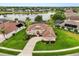 Beautifully landscaped home with lush green lawn, manicured garden beds, and a long driveway leading to a two-car garage at 14174 Islamorada Dr, Orlando, FL 32837