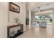 Inviting foyer featuring neutral walls, tile flooring, console table, and seamless flow into the living area at 14174 Islamorada Dr, Orlando, FL 32837