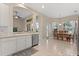Open-concept kitchen and dining area featuring white cabinets, stainless steel appliances, and views of the pool at 14174 Islamorada Dr, Orlando, FL 32837
