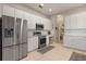 Well-equipped kitchen featuring white cabinets, stainless steel appliances, and tile flooring at 14174 Islamorada Dr, Orlando, FL 32837