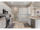 Bright kitchen featuring ample storage, modern appliances, and easy access to the laundry area at 14174 Islamorada Dr, Orlando, FL 32837