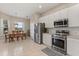 Spacious kitchen with white cabinets, stainless steel appliances, and an adjacent dining area with a pool view at 14174 Islamorada Dr, Orlando, FL 32837