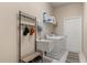 Functional laundry room with washer, dryer, sink, and storage shelves at 14174 Islamorada Dr, Orlando, FL 32837