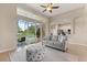 Bright living room featuring tile floors and glass doors leading to a screened lanai with a pool view at 14174 Islamorada Dr, Orlando, FL 32837