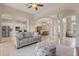 Bright, open-concept living room with tile floors, a gray sofa, and open views to the kitchen and dining room at 14174 Islamorada Dr, Orlando, FL 32837