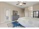 Relaxing main bedroom with dresser and decorative mirror, ceiling fan, and view to bathroom at 14174 Islamorada Dr, Orlando, FL 32837