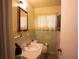 Traditional bathroom featuring a sink with vanity, window with blinds, and coordinated fixtures at 1418 Oregon St, Orlando, FL 32803