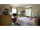 Comfortable bedroom with natural light, complemented by floral accents and ample storage at 1418 Oregon St, Orlando, FL 32803