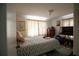 Bedroom with a queen-size bed, dresser, TV and multiple windows that provide natural light at 1418 Oregon St, Orlando, FL 32803