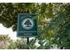 Close up of 'Colonialtown North' welcome sign, emphasizing the neighborhood's identity and lush greenery at 1418 Oregon St, Orlando, FL 32803