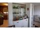 Bright dining area featuring built-in china cabinet with glass doors for displaying collectibles and a view to the kitchen at 1418 Oregon St, Orlando, FL 32803