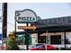 Eye-catching Pigzza restaurant sign in the Mills 50 District, pointing customers towards the establishment at 1418 Oregon St, Orlando, FL 32803