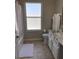 Neutral bathroom featuring a toilet, vanity with granite counters, tile floor, and frosted window at 1428 Casterton Cir, Davenport, FL 33897