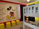 ' themed bedroom with bunk beds and colorful Mickey Mouse wall decor at 1428 Casterton Cir, Davenport, FL 33897