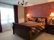 Themed bedroom featuring unique brick wall decor and a sleigh bed with matching lamps at 1428 Casterton Cir, Davenport, FL 33897