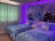 Themed bedroom with two twin beds and vibrant murals, great for children at 1428 Casterton Cir, Davenport, FL 33897