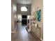 Bright entryway featuring high ceilings, hardwood floors, modern decor, and open access to the living room at 1428 Casterton Cir, Davenport, FL 33897