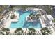 Aerial shot of the uniquely shaped community pool surrounded by chairs, palm trees, and lush landscaping at 1461 Santorini Way, Tavares, FL 32778