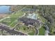 Aerial view of Primary-planned community with amenity center, pool, pickleball courts, and pond at 1461 Santorini Way, Tavares, FL 32778