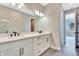 Bathroom featuring a double sink vanity with black fixtures and view to another room at 1461 Santorini Way, Tavares, FL 32778