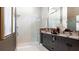 Modern bathroom featuring a double vanity, granite countertop, and a walk-in shower with glass door at 1461 Santorini Way, Tavares, FL 32778
