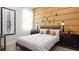 Stylish bedroom with a modern bed, decorative wall art, and window, creating a peaceful and inviting atmosphere at 1461 Santorini Way, Tavares, FL 32778