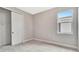 Cozy bedroom with neutral carpet, gray walls, a window with a view, and a closet with sliding doors at 1461 Santorini Way, Tavares, FL 32778