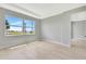Bedroom featuring neutral walls, light wood flooring, a trey ceiling, and a large window at 1461 Santorini Way, Tavares, FL 32778